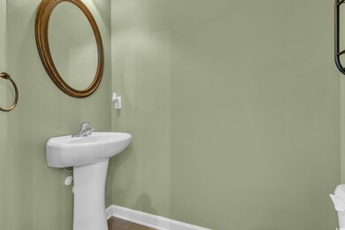 Bathroom with tile patterned floors and baseboards