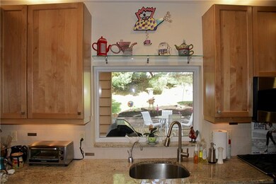 Kitchen window overlooking beautiful deck and gard