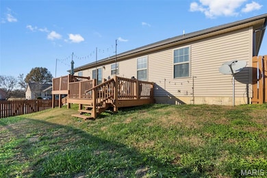 Back of property with a deck