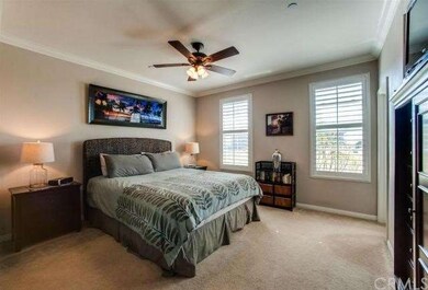 Master suite has plantation shutters, crown mouldi