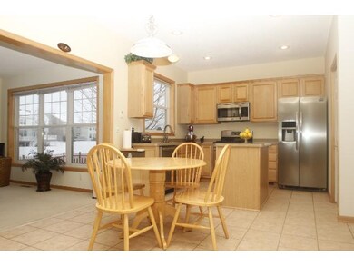 Kitchen features tile flooring, above-the-sink win