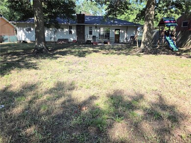Rear view of property with a chimney and a playground