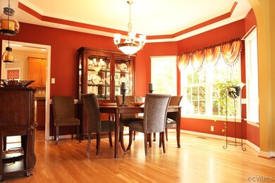 Formal dining with a tray ceiling, hardwood floori