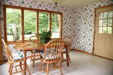 The sunroom/dining room is cheerful and airy
