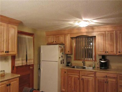 Kitchen. New kitchen leads to side door and covere