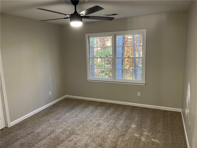Spare room featuring carpet flooring and ceiling fan