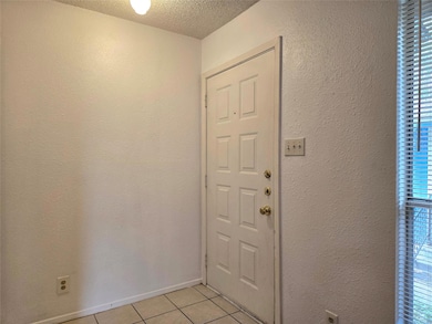Doorway to outside with light tile patterned floo