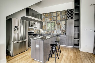 Modern kitchen features granite countertops, stain