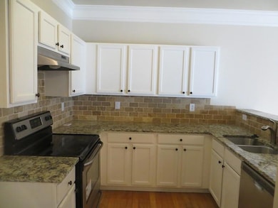 Kitchen featuring ornamental molding, appliances w