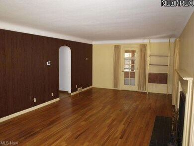 Other view of living room with door to sun room