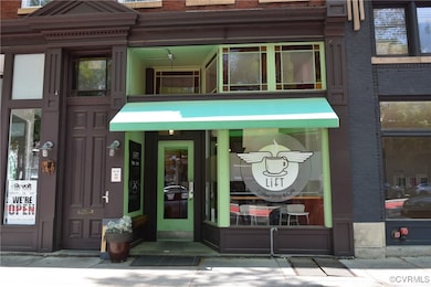 View of exterior entry featuring brick siding