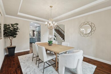 Dining space featuring sink, crown molding, a tray