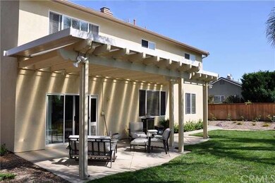 Relaxing backyard with high trellis has lighting