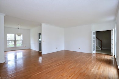 Formal living room, looking into formal dining room and entry foyer through the french doors