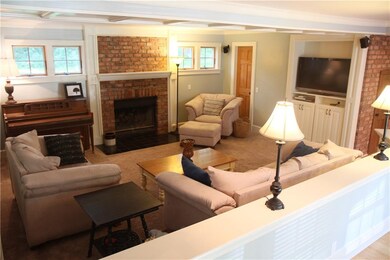 Living room with wood burning fireplace and lots o
