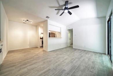 Unfurnished living room featuring a ceiling fan, 