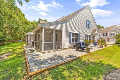 Back of house with a patio and a yard