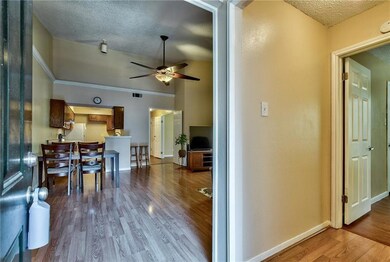 Kitchen with electric range, sink, dark tile floor