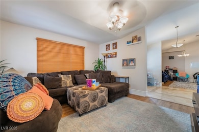 Living area featuring vaulted ceiling, an inviting
