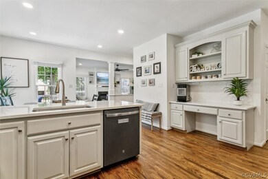 Kitchen featuring white cabinets, dark hardwood /