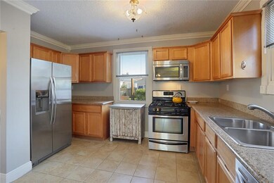 Open kitchen has tons of cabinets and granite coun