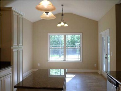 Large breakfast nook with french doors to screened porch.