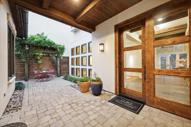 COURTYARD - Iron gates open to a quaint front cour
