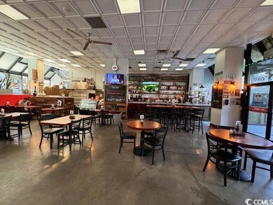 Dining space with finished concrete flooring and a community bar