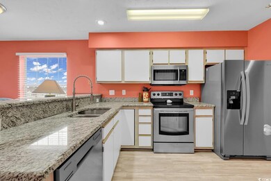 Kitchen featuring light wood-style flooring, appliances with stainless steel finishes, white cabinetry, and a sink