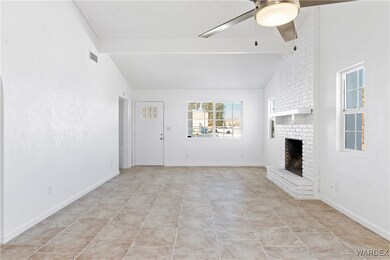 Unfurnished living room featuring tile patterned f