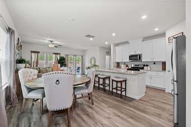 Dining space with light hardwood / wood-style floo