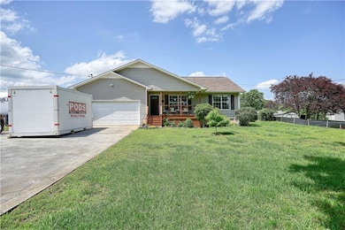Ranch-style house with covered porch, a garage, dr
