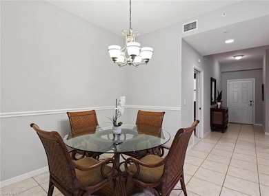 Tiled dining area with a chandelier