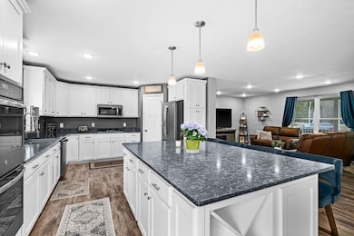 Kitchen with open floor plan, dark wood finished f