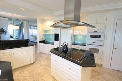 Kitchen with double oven, black electric stovetop,