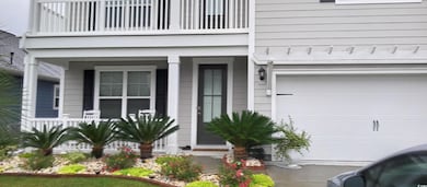 Doorway to property featuring a garage and a balco