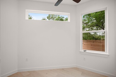 Unfurnished room with ceiling fan and light wood-
