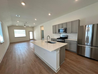 Kitchen featuring stainless steel appliances, gra