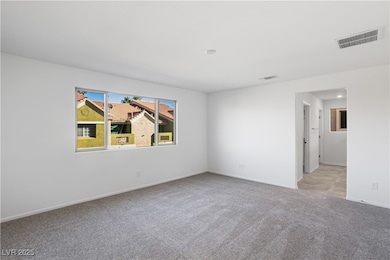 Spare room with light carpet and baseboards