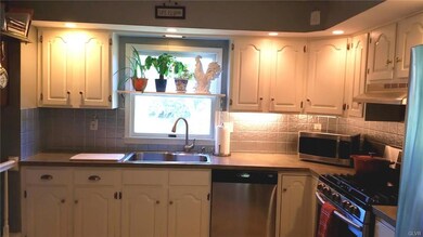Kitchen is updated and overlooks the backyard.