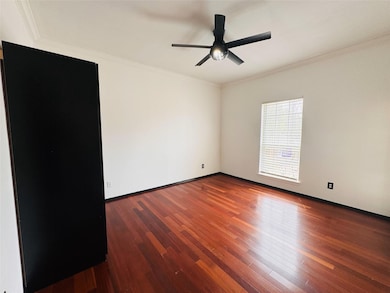 Bedroom 1 with wood finished floors, ceiling fan, 