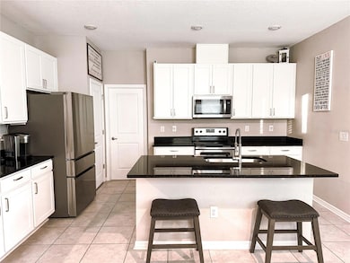 Kitchen with granite counters and white cabinets