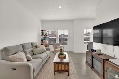 Living room featuring light wood-style floors and a textured ceiling