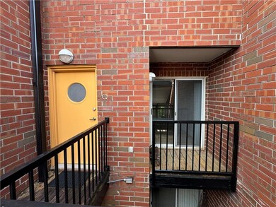 Property entrance featuring brick siding