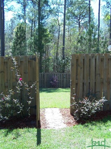 Step through here to the large fenced backyard.