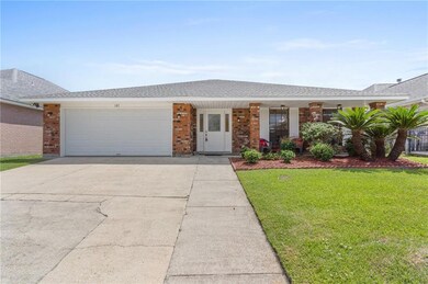 Front view of 107 Sirius Lane in Eden Isles.  Brick home on water with boat house and hoist.  Press a button and your boat is in the water.  Lovely deck over the water too.