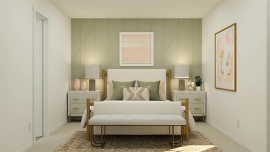 Bedroom featuring light carpet and baseboards