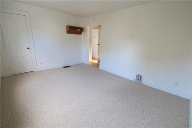 Living room empty with brand new carpet.
