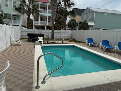 View of pool featuring a fenced backyard and a pat