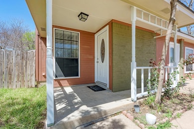Entrance to property featuring brick siding, a po